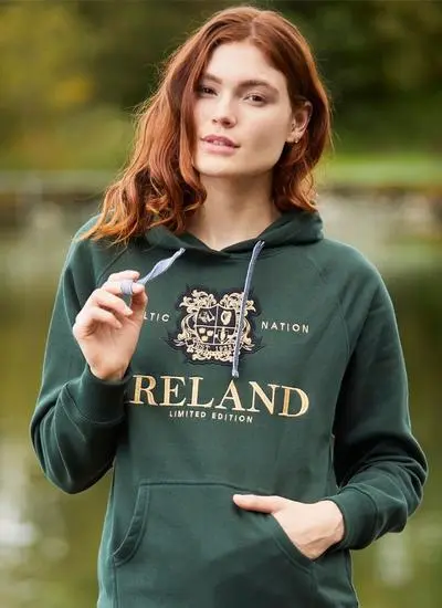 Red haired woman outside wearing green Celtic hoodie